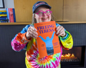 Terea holding her copy of the book, 'FRreeing Teresa"
