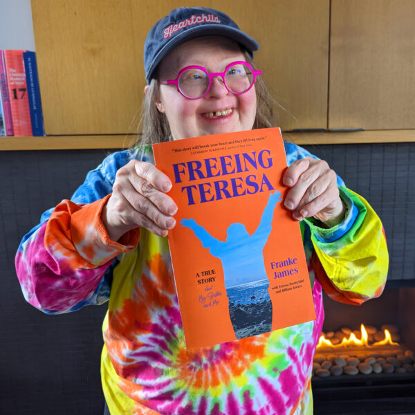 Terea holding her copy of the book, 'FRreeing Teresa"
