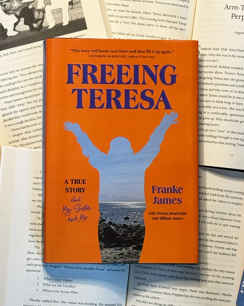 Freeing Teresa colour hardcover with an orange cover and blue silhouette of Teresa raising her arms overhead. Her body is filled with a photo of blue sky, low mountains, and a sandy, rocky beach;