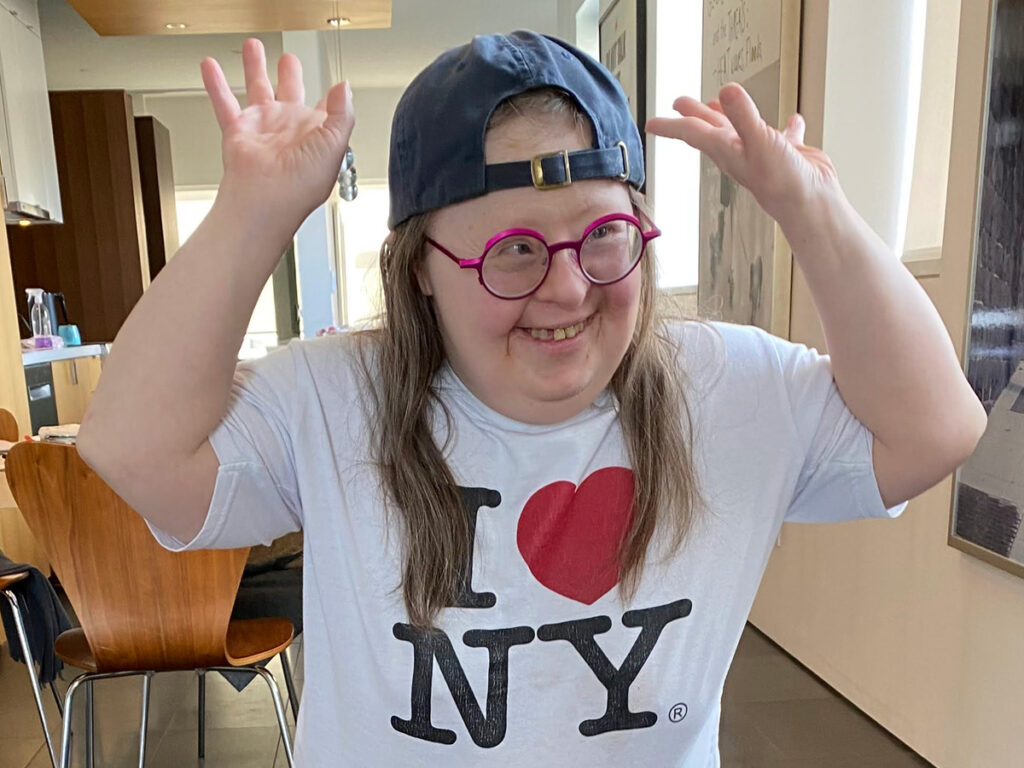 
Teresa at home in Vancouver, wearing a big smile and a favourite I Love NY shirt